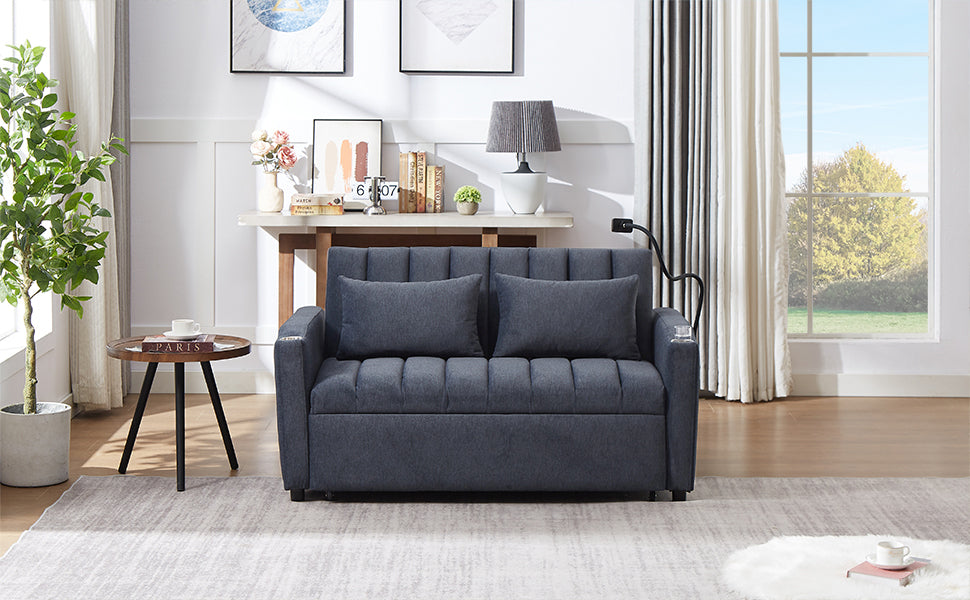 Dark gray upholstered sofa with tufted seat and back cushions two throw pillows
