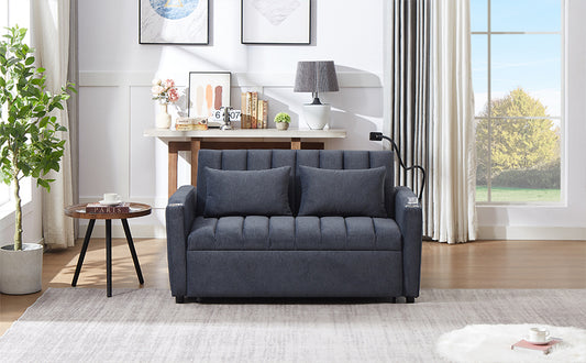 Dark gray upholstered sofa with tufted seat and back cushions two throw pillows