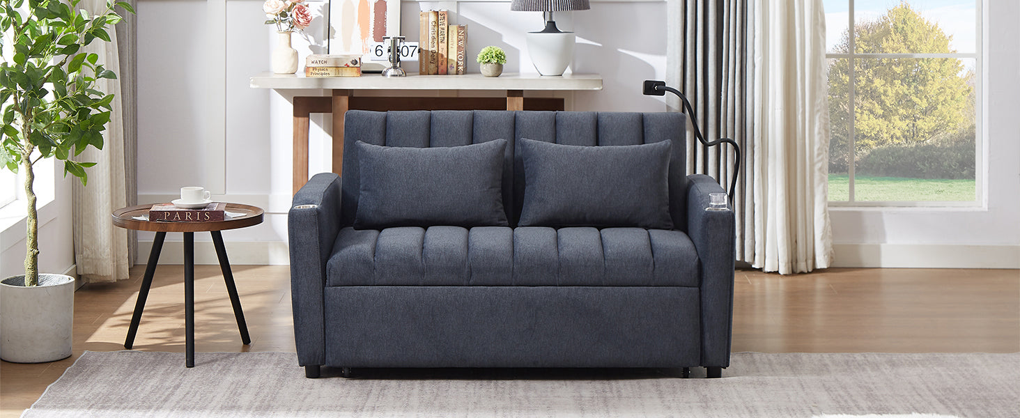 Dark grey upholstered sofa bed with channel tufting and two throw pillows