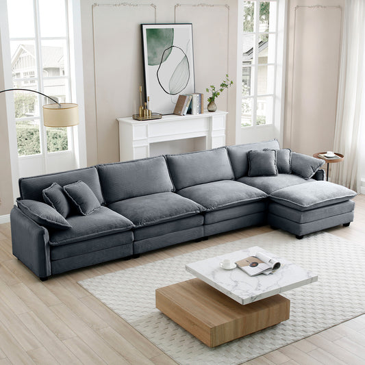 Plush charcoal gray corduroy sectional sofa with deep cushions and multiple throw pillows perfect for a modern living room