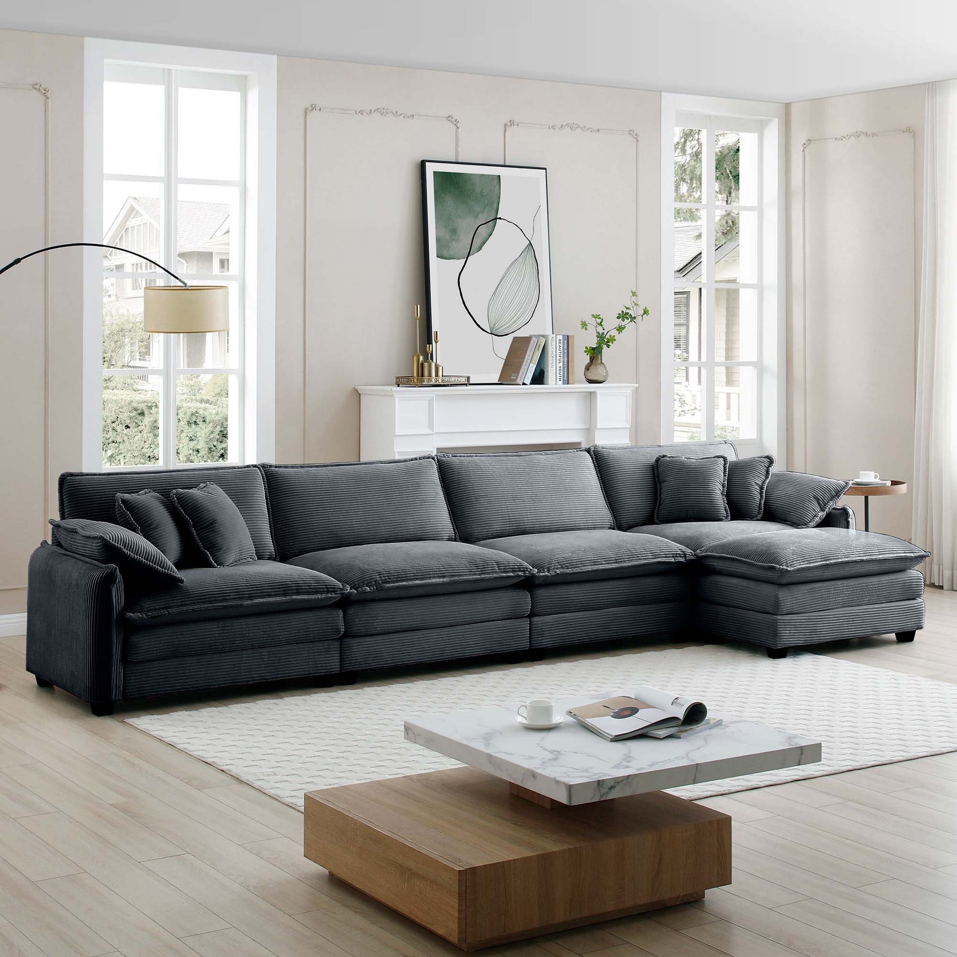 Dark gray corduroy sectional sofa with plush cushions and a chaise lounge