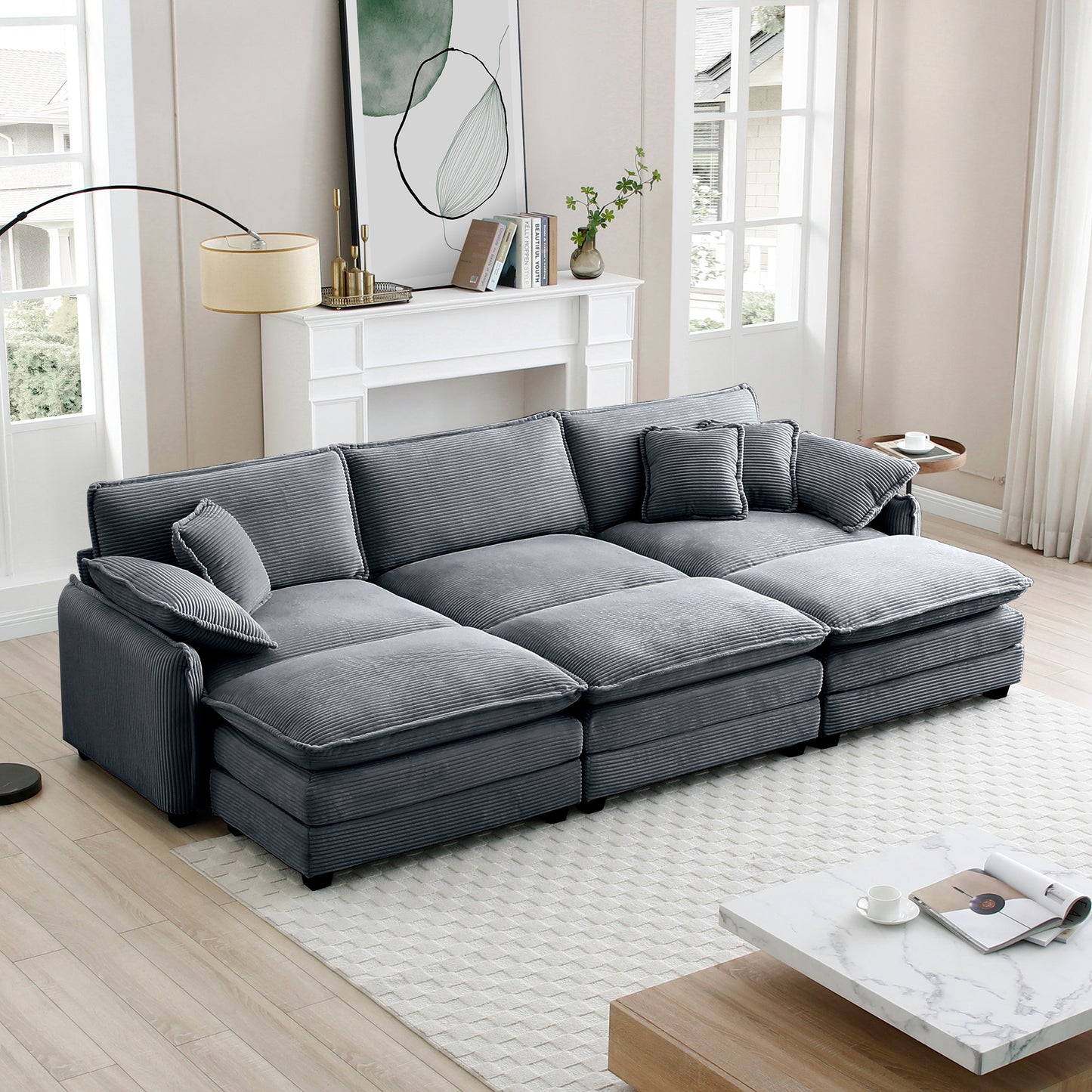 Plush grey corduroy sectional sofa with multiple cushions and chaise lounge