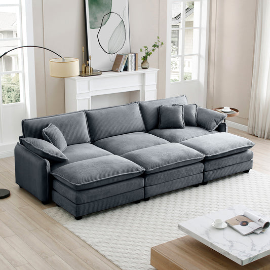 Plush grey corduroy sectional sofa with multiple cushions and chaise lounge