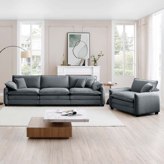 Dark grey corduroy sectional sofa with plush cushions and matching armchair