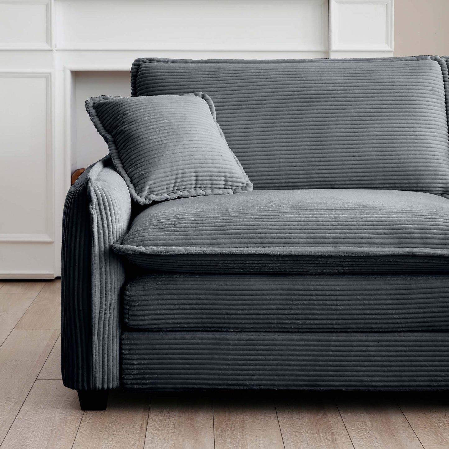 Dark grey corduroy sofa with plush cushions and modern design