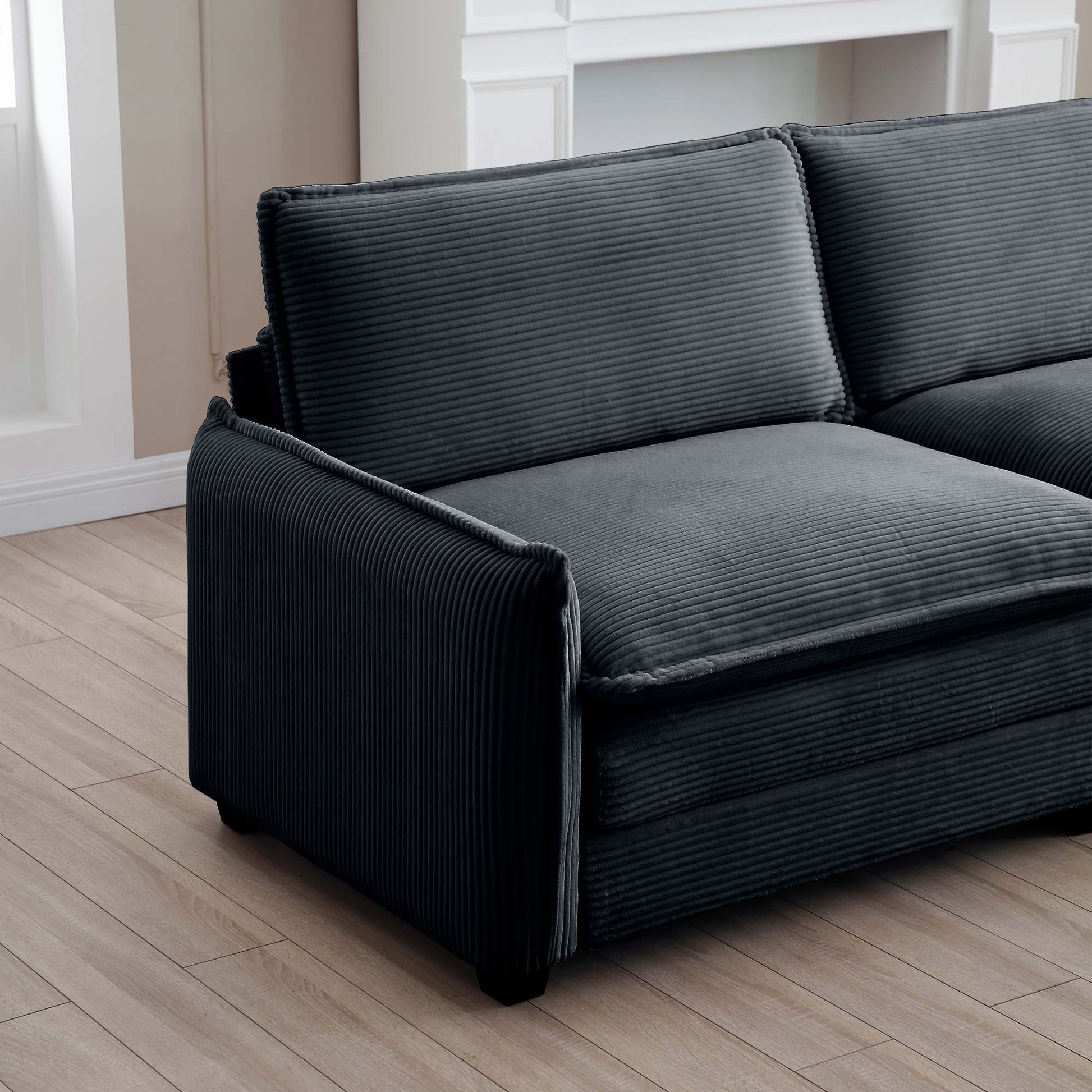 Dark charcoal corduroy sofa with plush cushions perfect for a cozy living room