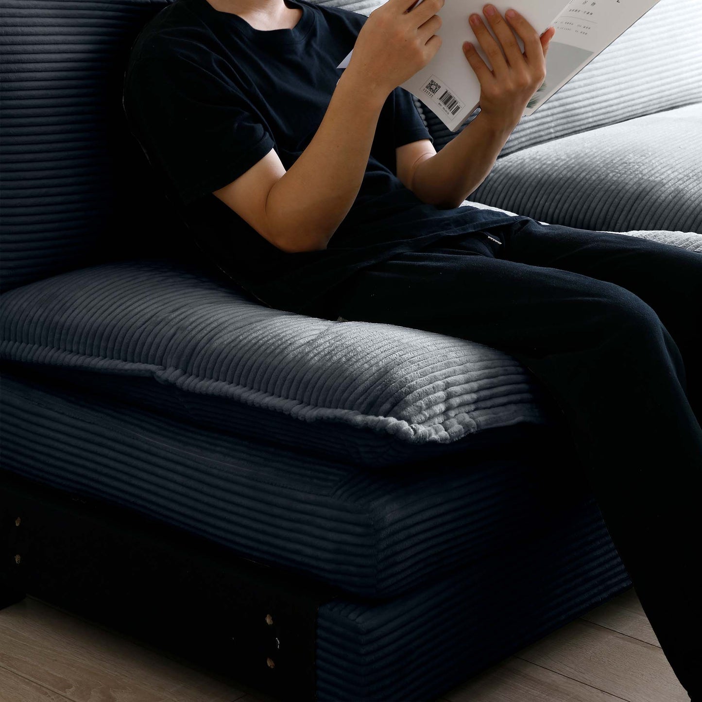 Closeup of a dark gray corduroy sectional sofa with plush cushions ideal for a living room