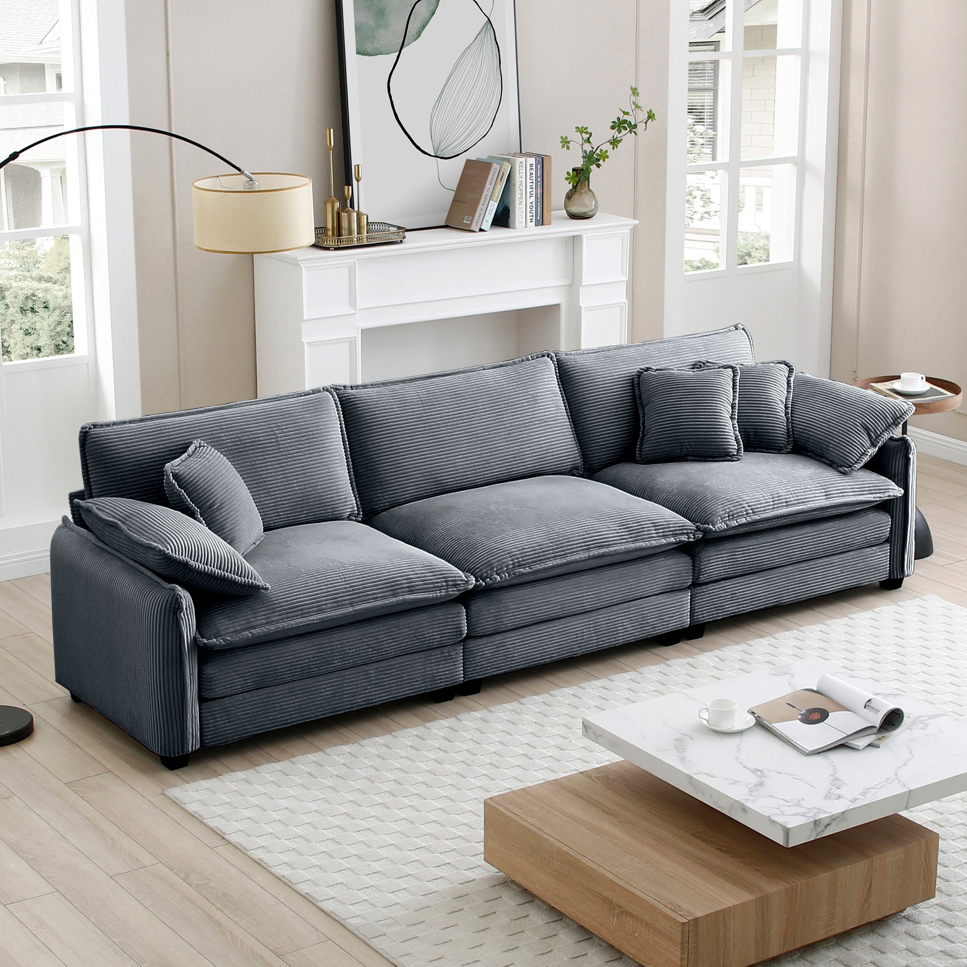 Gray corduroy sectional sofa with plush cushions and matching throw pillows