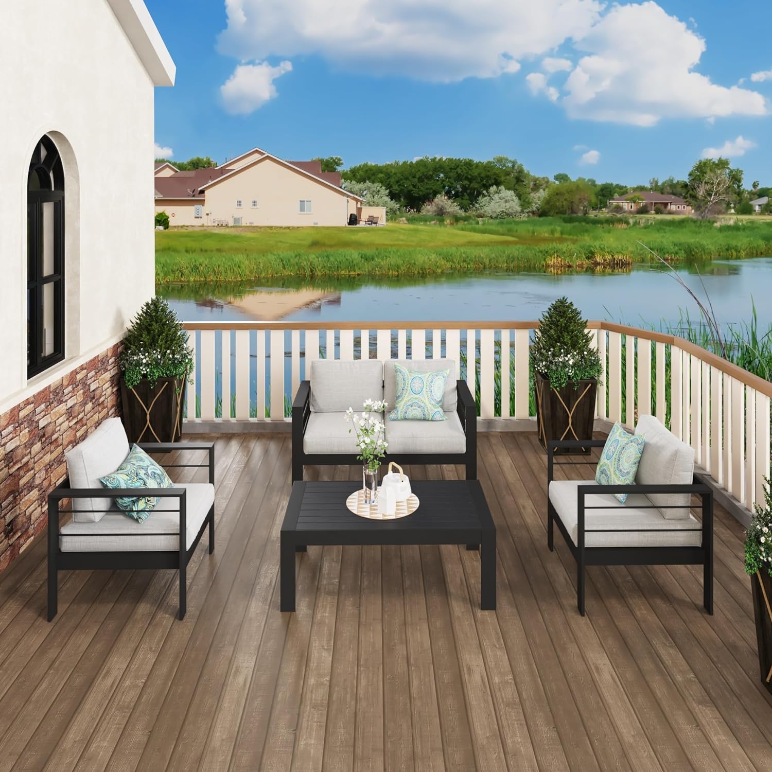 Modern black metal patio furniture set with grey cushions and abstract pillows
