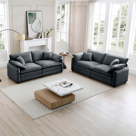Dark gray corduroy sectional sofa with plush pillows in a modern living room setting