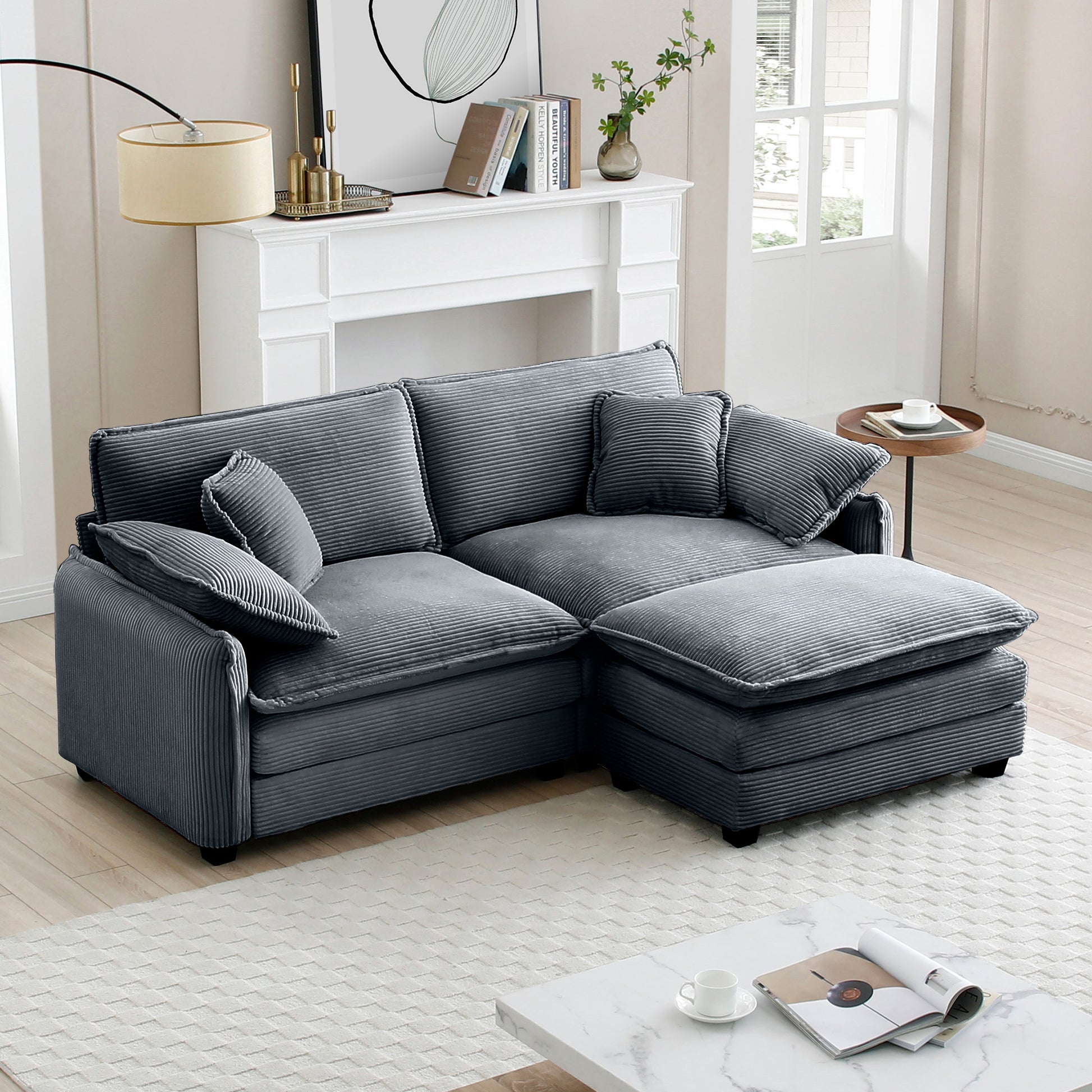 Dark gray corduroy sectional sofa with ottoman and accent pillows