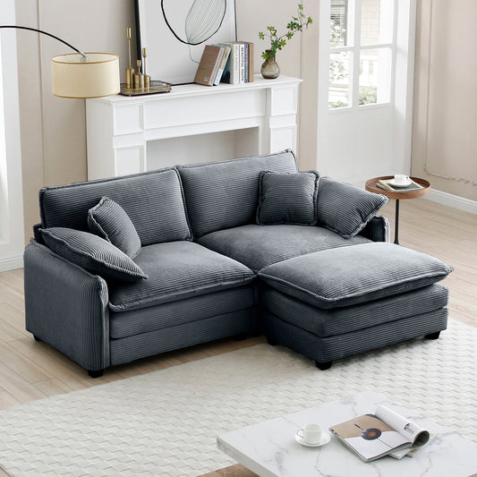Dark gray corduroy sectional sofa with ottoman and accent pillows