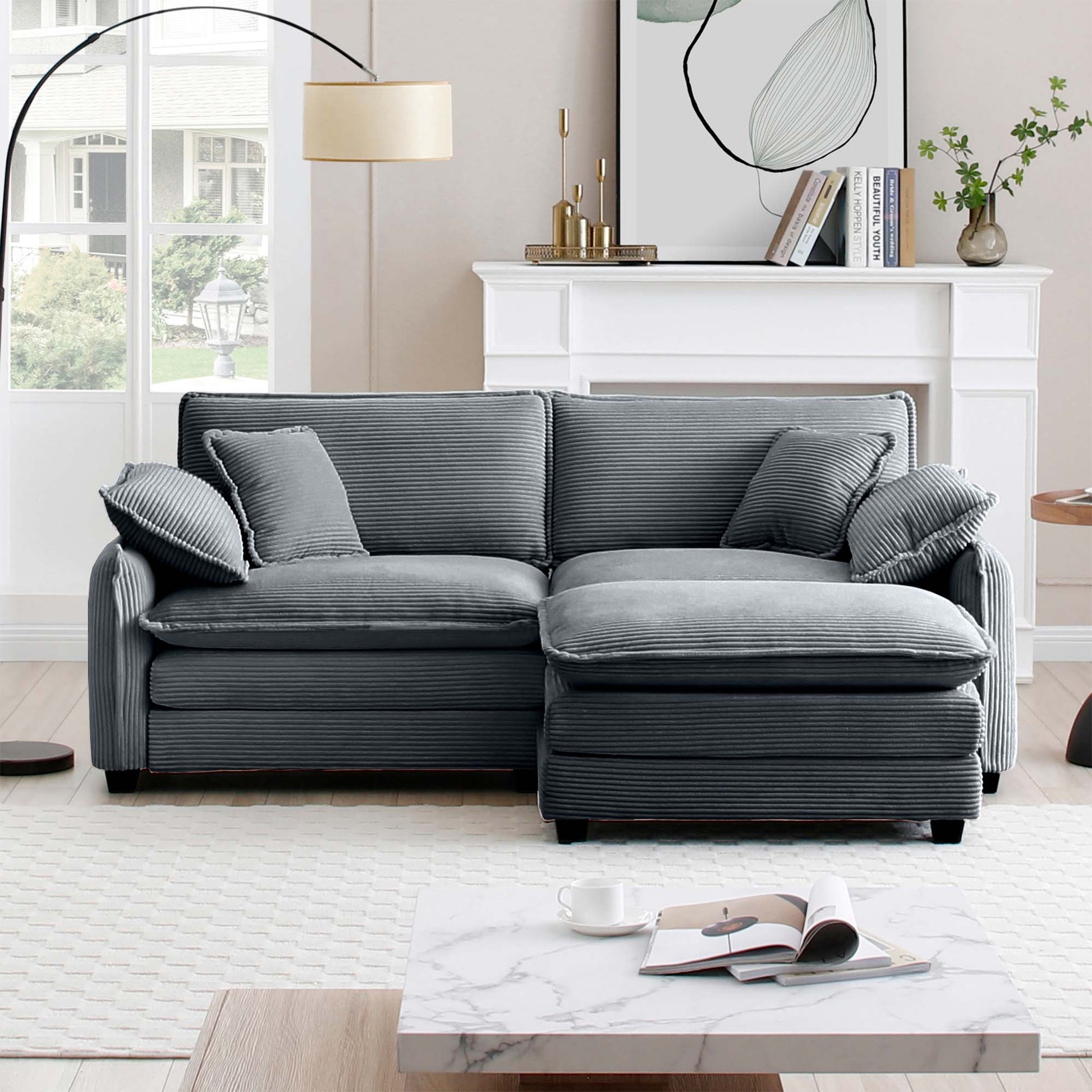 Dark grey corduroy sectional sofa with plush cushions and ottoman