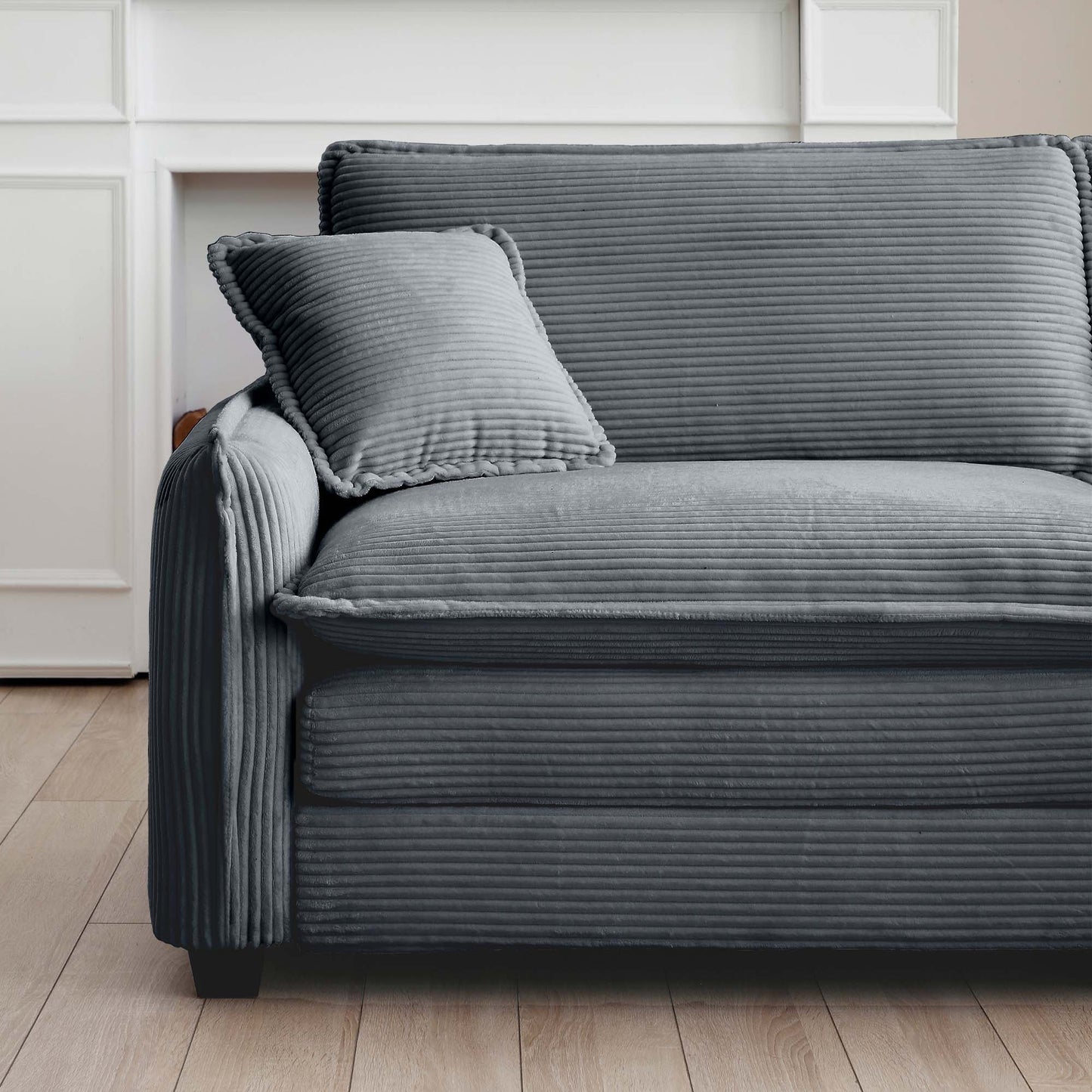 Closeup of a comfortable dark grey corduroy sofa with plush cushions