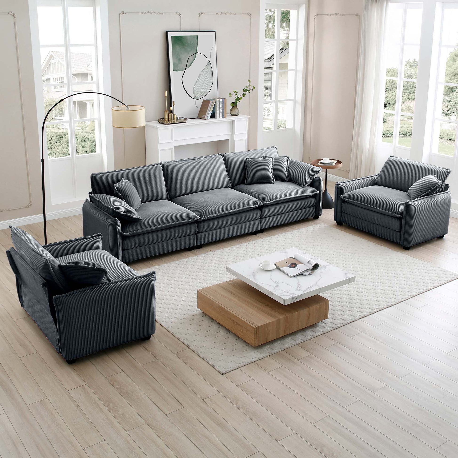 Dark grey corduroy sectional sofa with plush cushions and matching armchairs