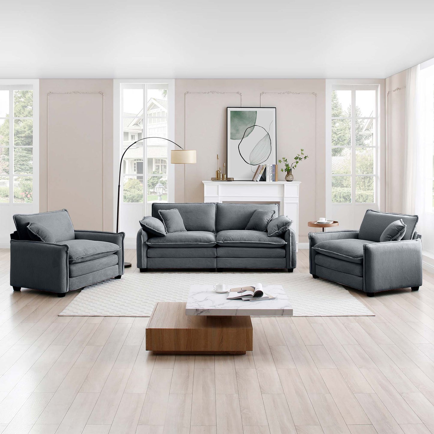 Dark gray corduroy fabric sofa with plush cushions and matching armchairs