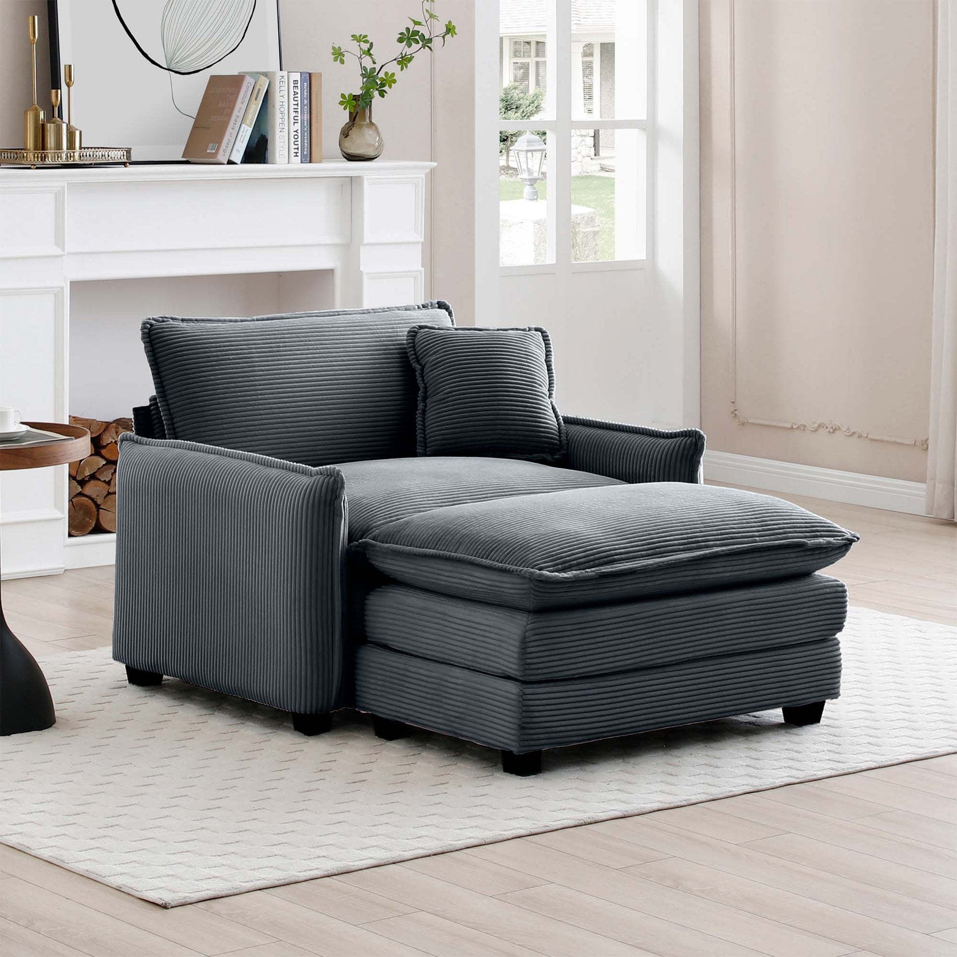 Gray corduroy chaise lounge with plush cushions and a matching throw pillow