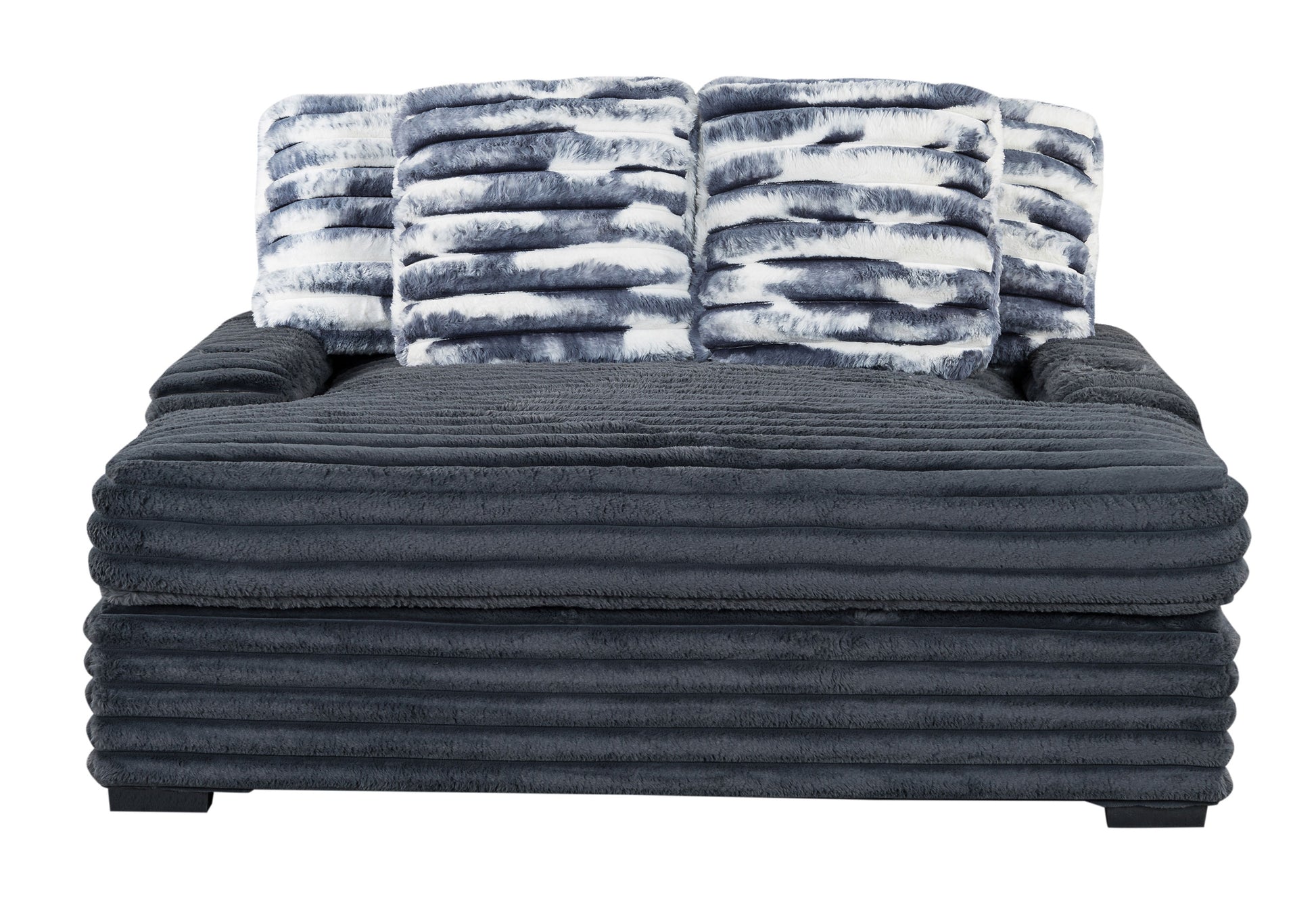 Plush dark grey sectional sofa with four faux fur throw pillows in blue and white tiedye pattern