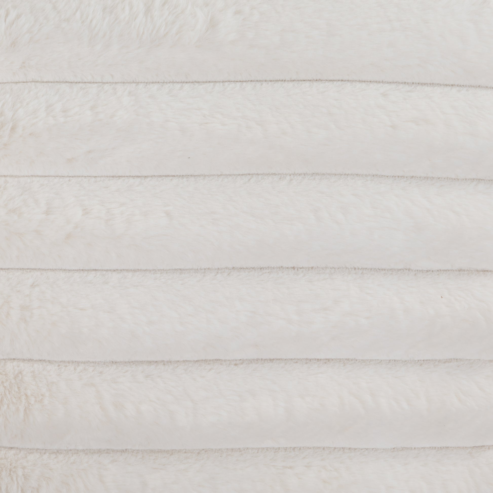 Plush white faux fur fabric with horizontal stitching ideal for blankets and throws