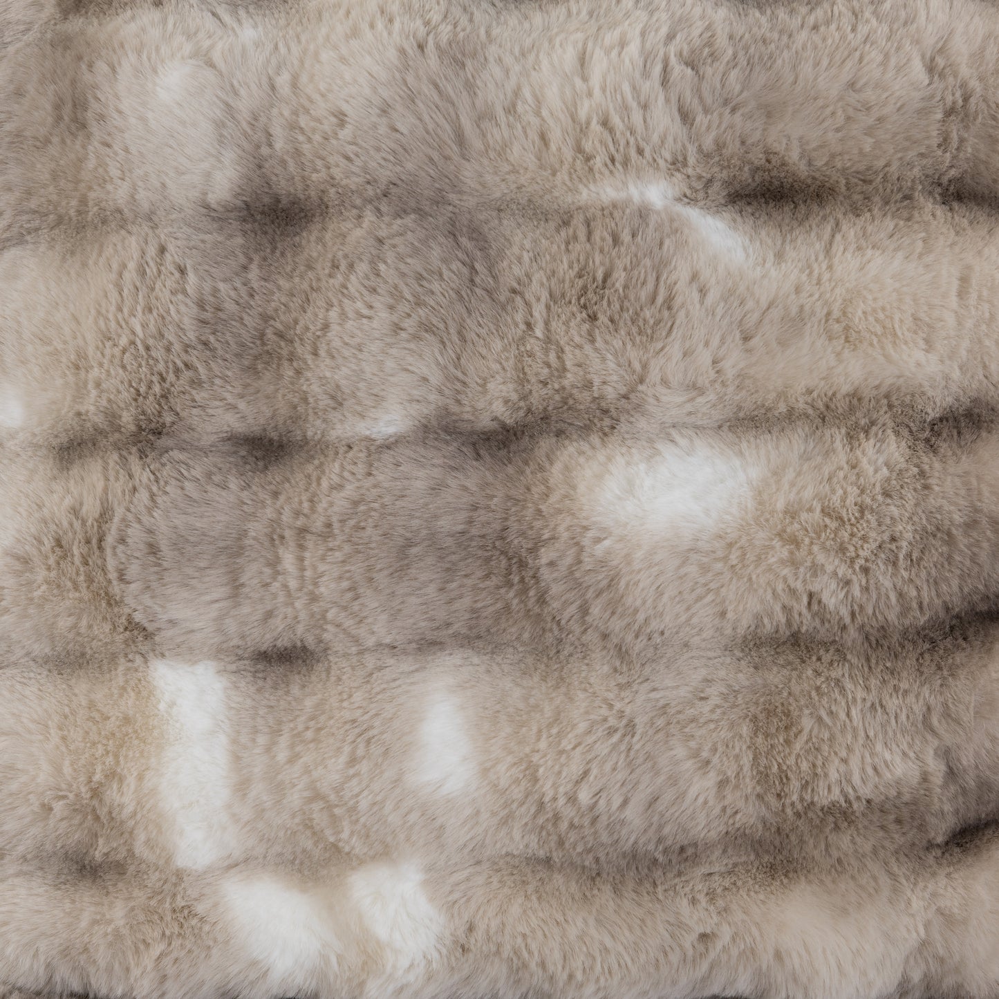 Closeup texture of luxurious plush faux fur in natural taupe and cream tones
