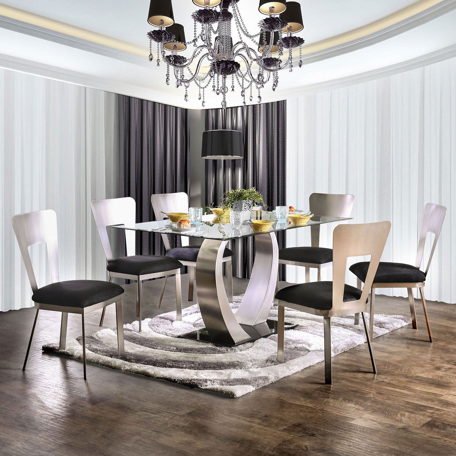Modern glass dining table with stainless steel base and six black upholstered chairs