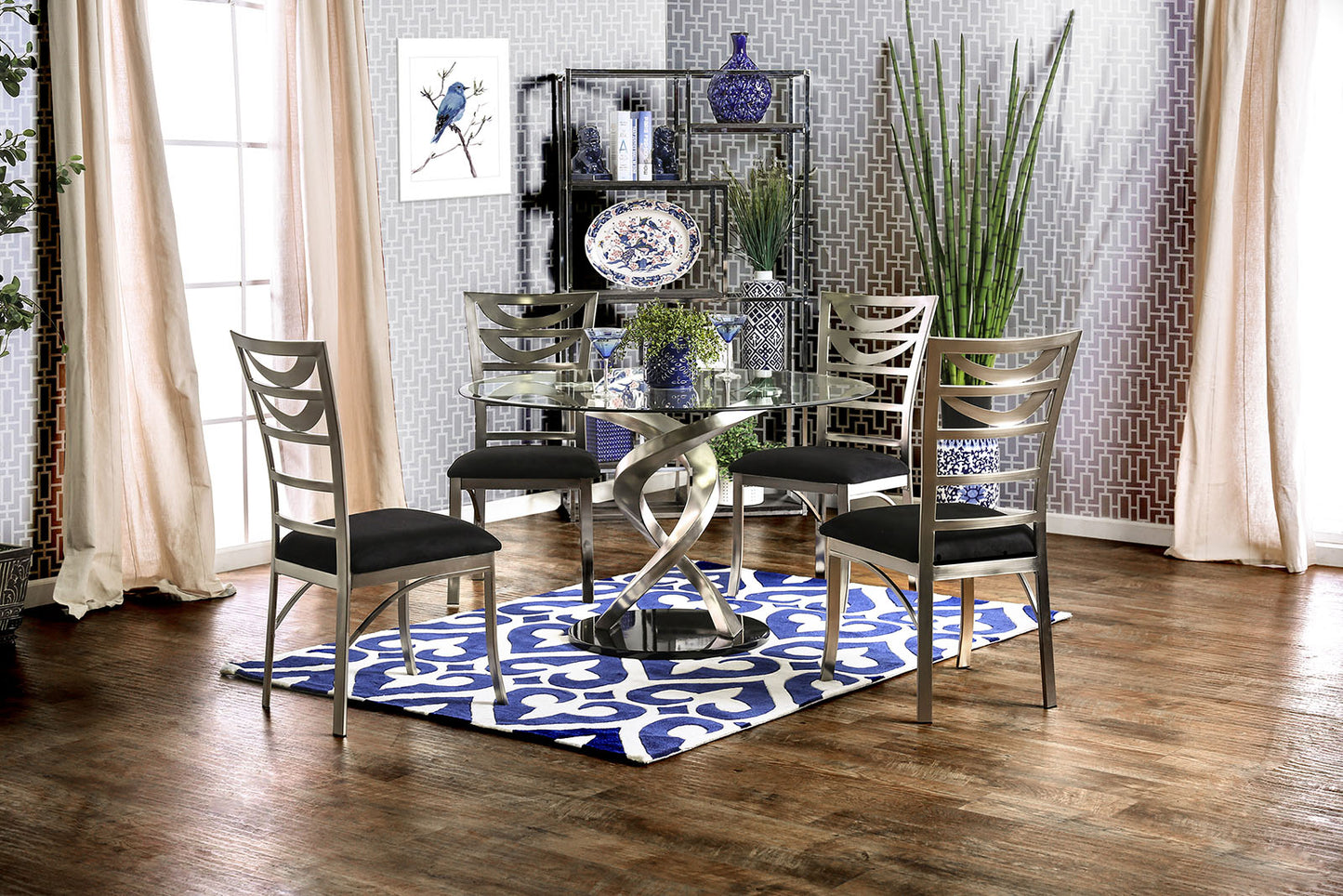 Round glass dining table with silver spiral base and four black upholstered chairs