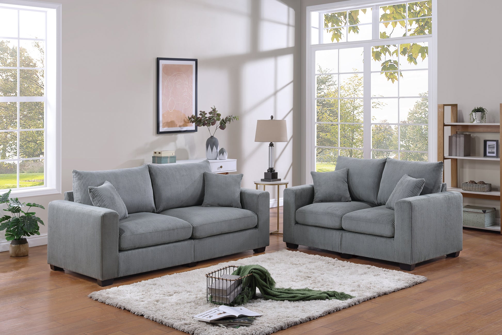 Twoseater grey corduroy sofa with plush cushions and contemporary design