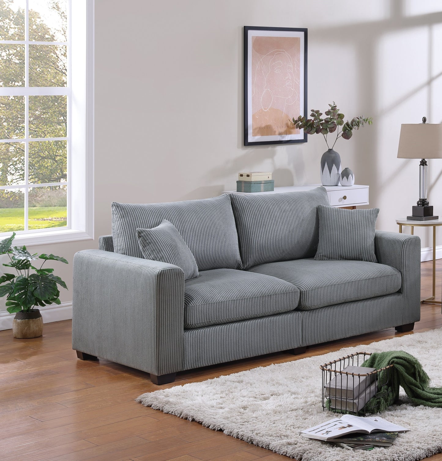 Plush grey corduroy sofa with two throw pillows ideal for modern living room decor