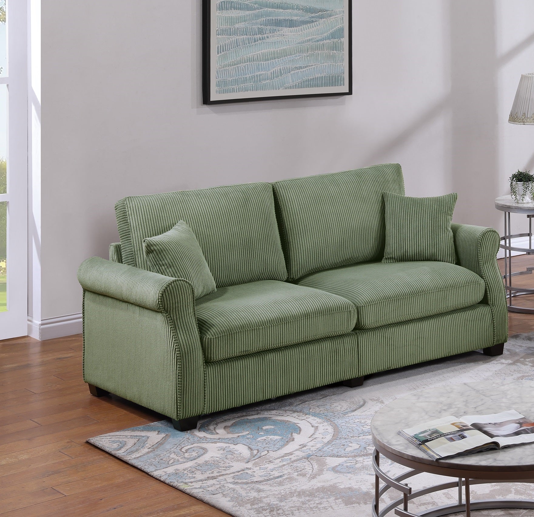Sage green corduroy sofa with plush cushions and decorative piping perfect for living rooms