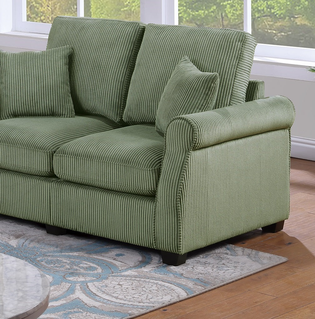 Green corduroy sofa with rolled arms and plush cushions inviting comfort