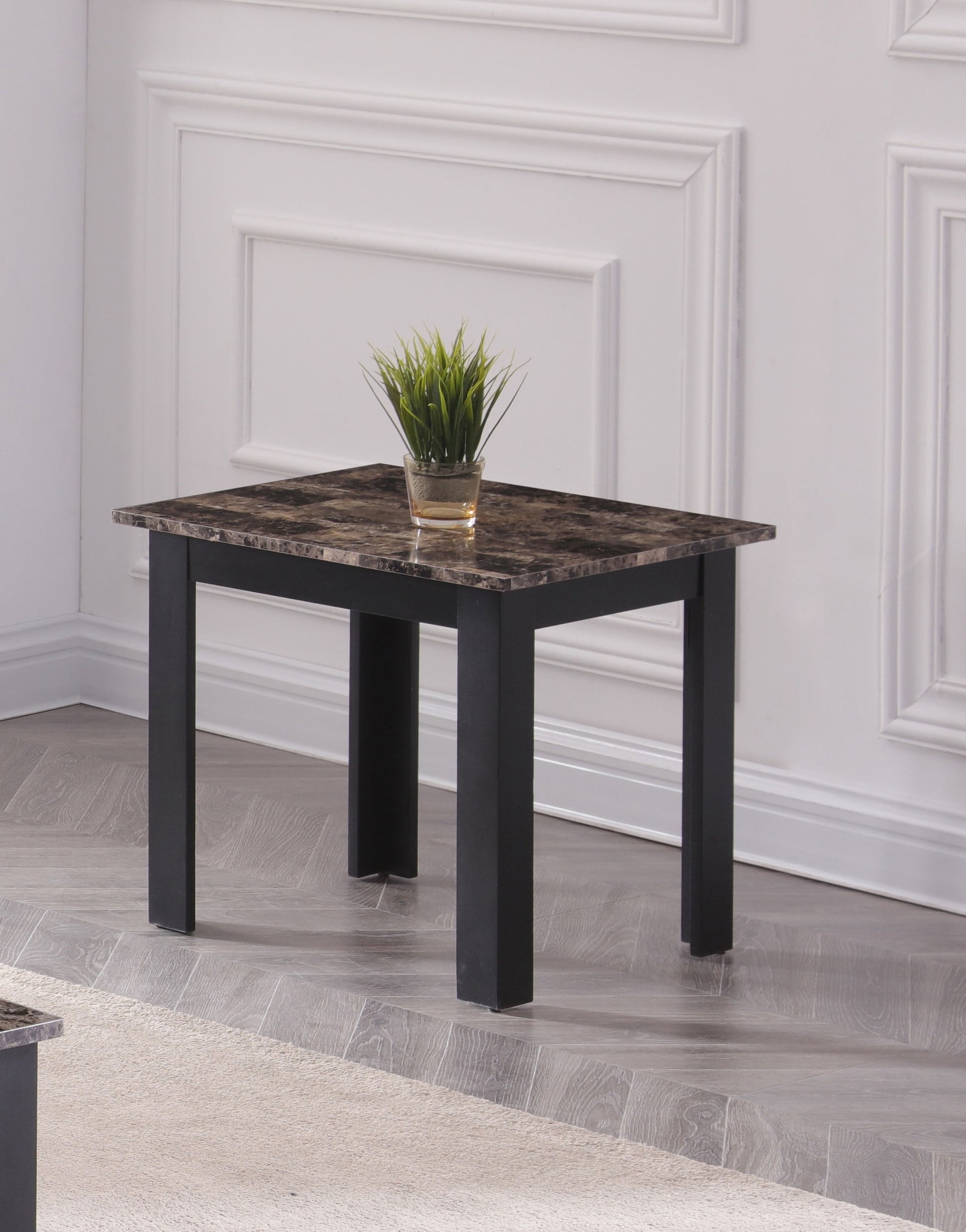 Black leg marble top end table with a small potted plant