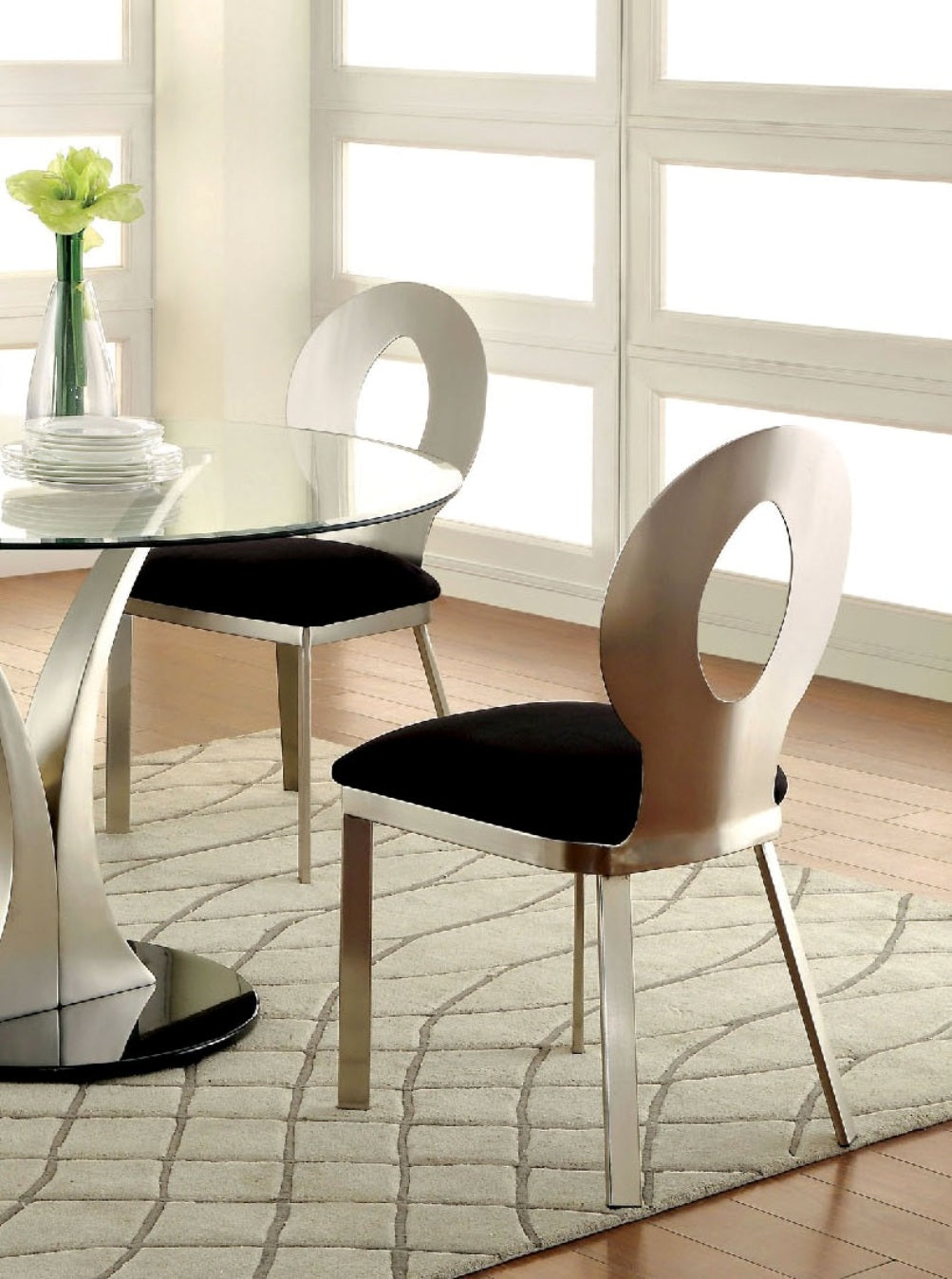 Modern brushed metal dining chair with black upholstered seat and open oval back