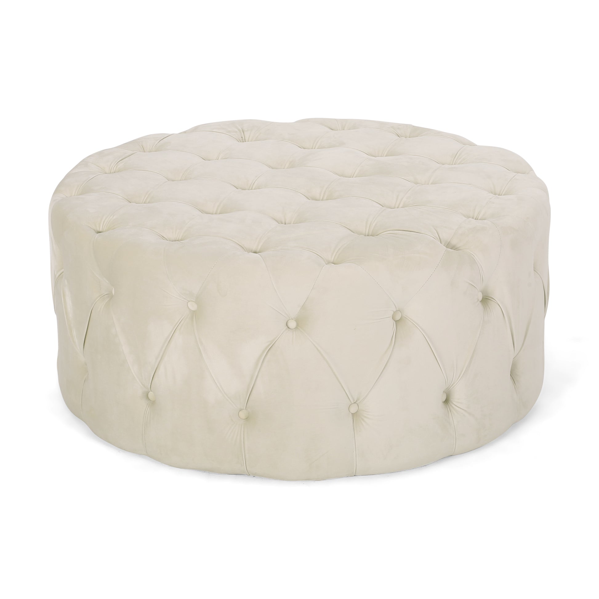 Round beige velvet ottoman with deep button tufting and a plush top surface