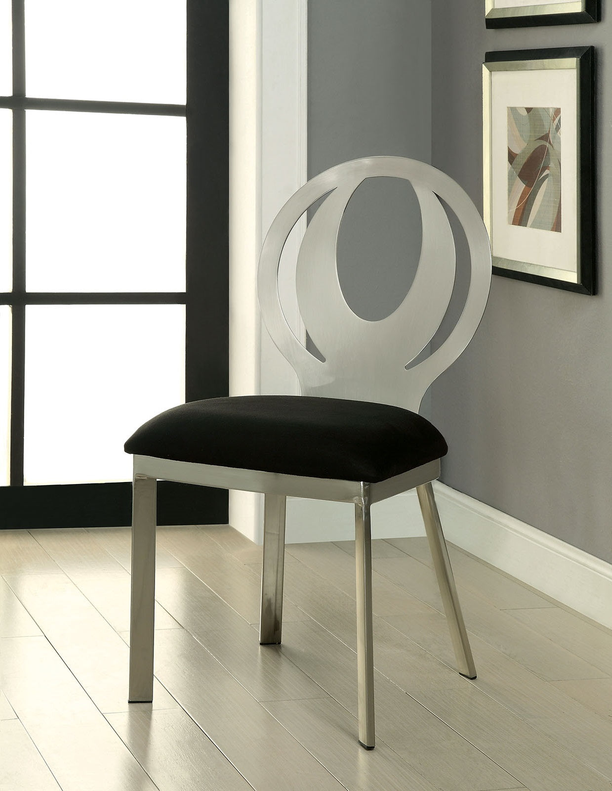 Sleek silver chair with black upholstered seat and unique circular back