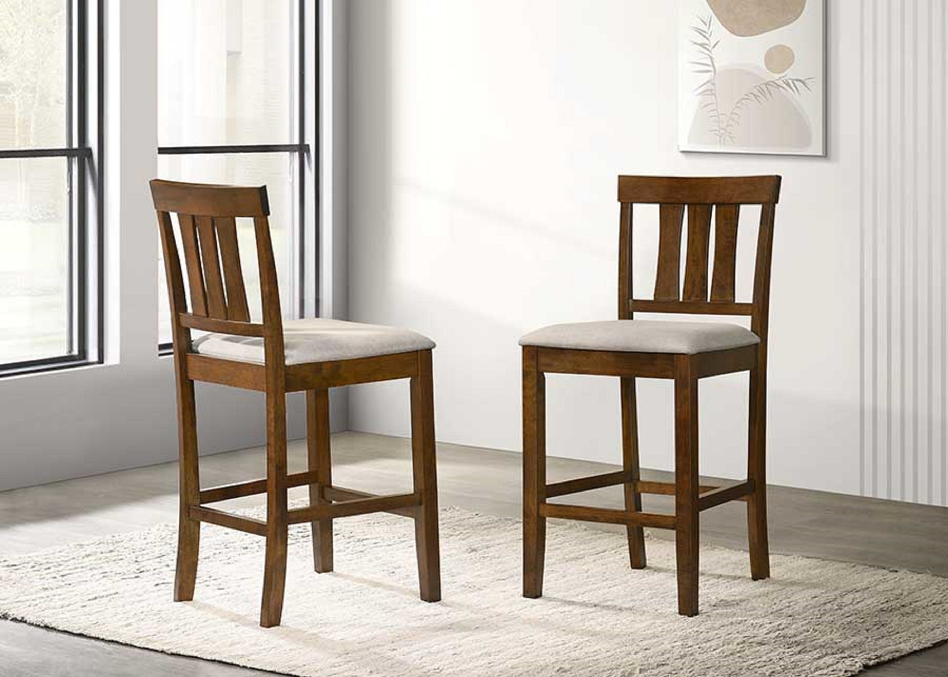 Two wooden bar stools with light grey upholstered seats and slatted backs