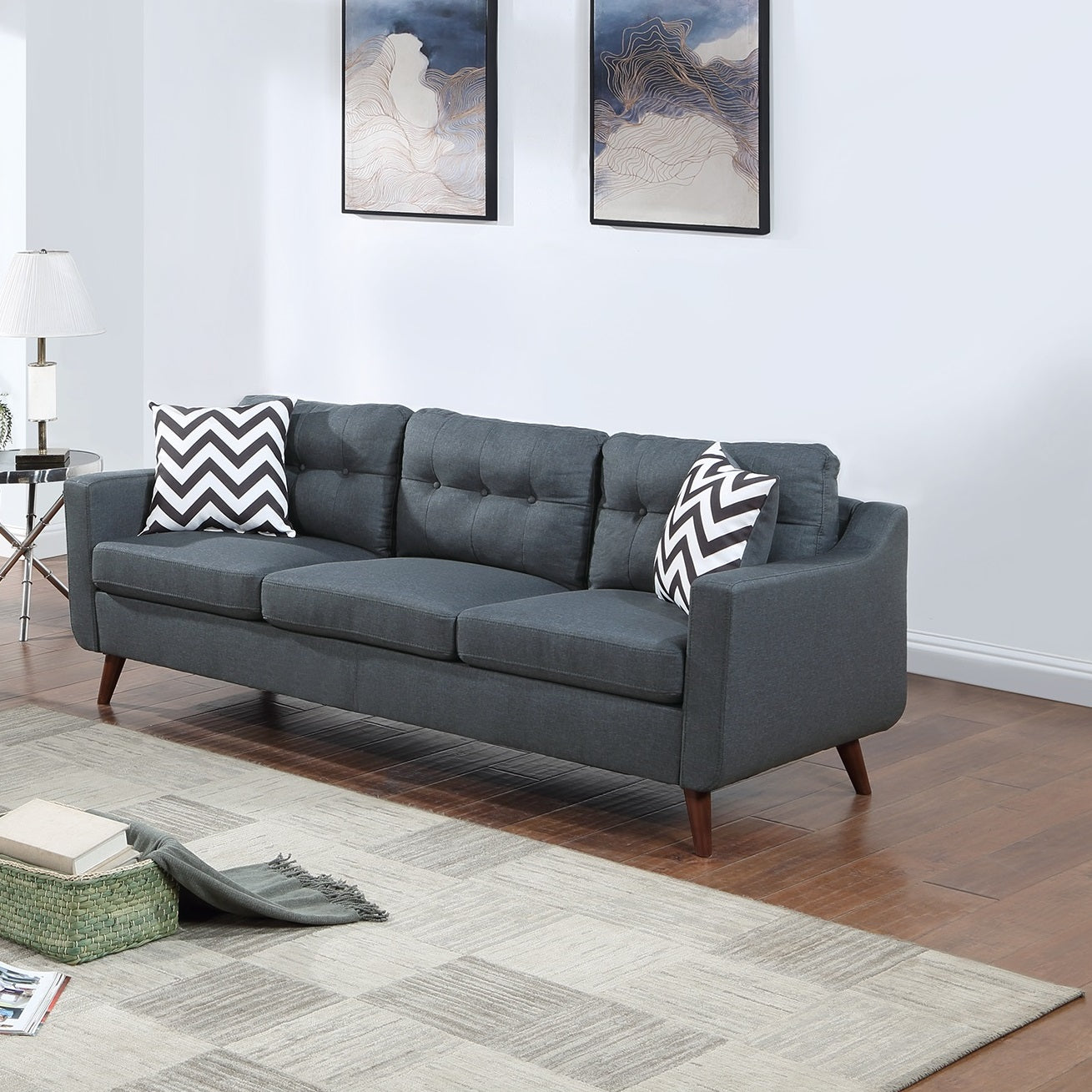 Dark gray fabric sofa with tufted back and wood legs midcentury modern design