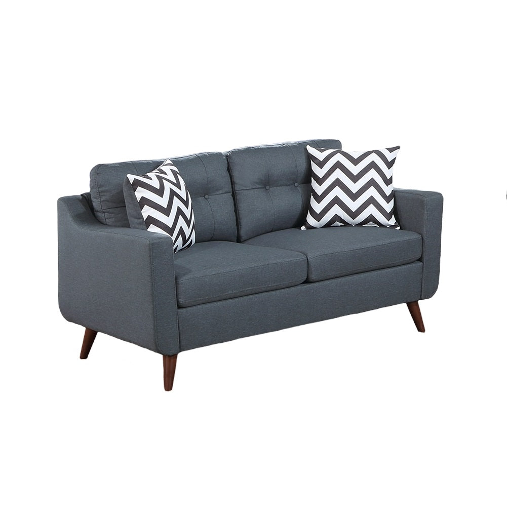 Gray fabric loveseat with tufted back and chevron pillows