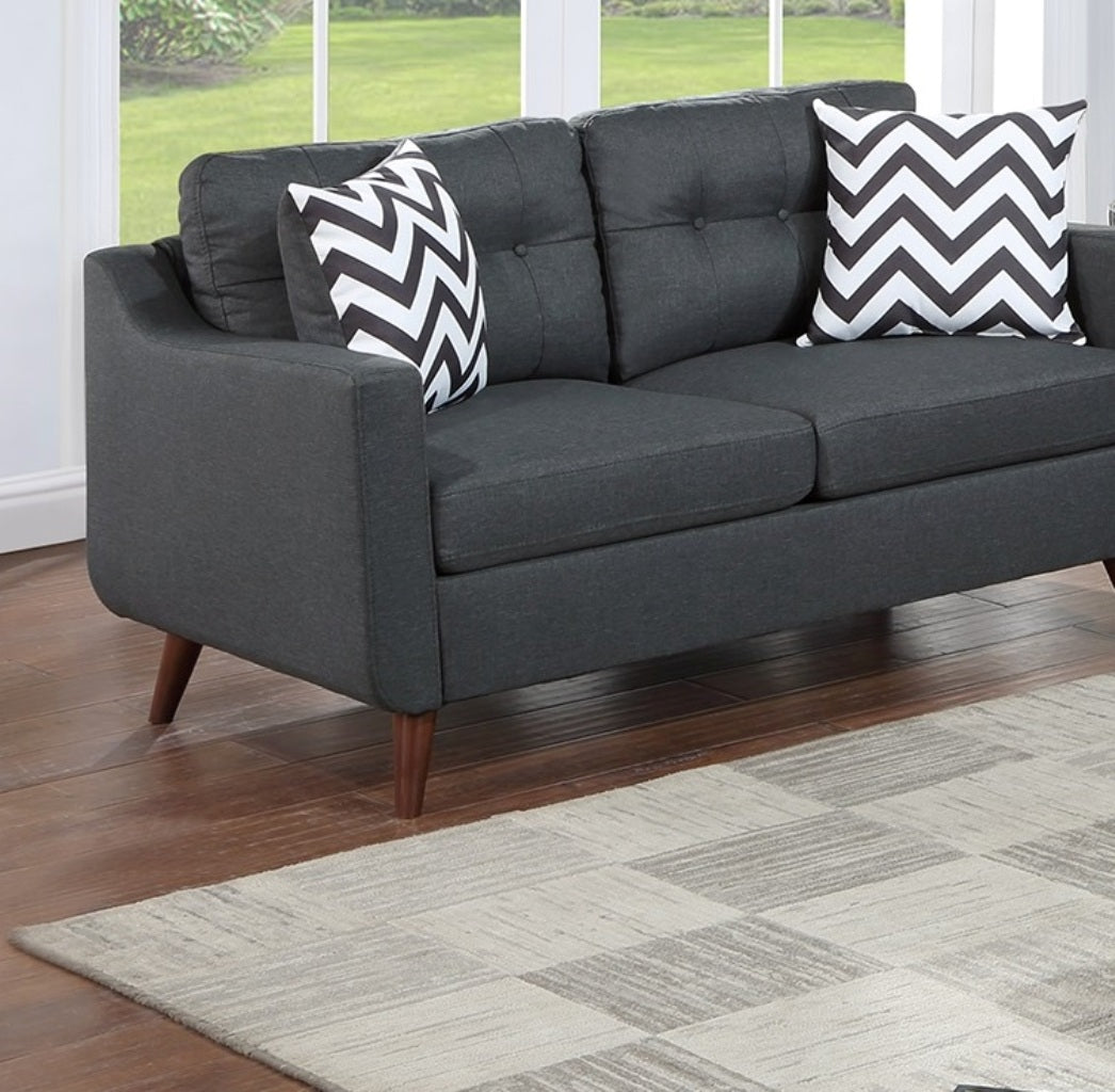 Modern charcoal grey sofa with tufted cushions and chevron throw pillows