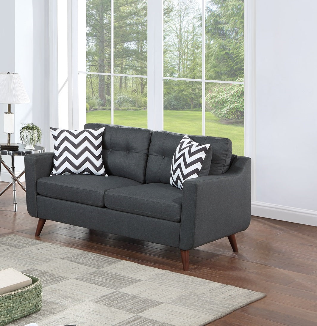 Dark grey fabric loveseat with tufted back and chevron pillows