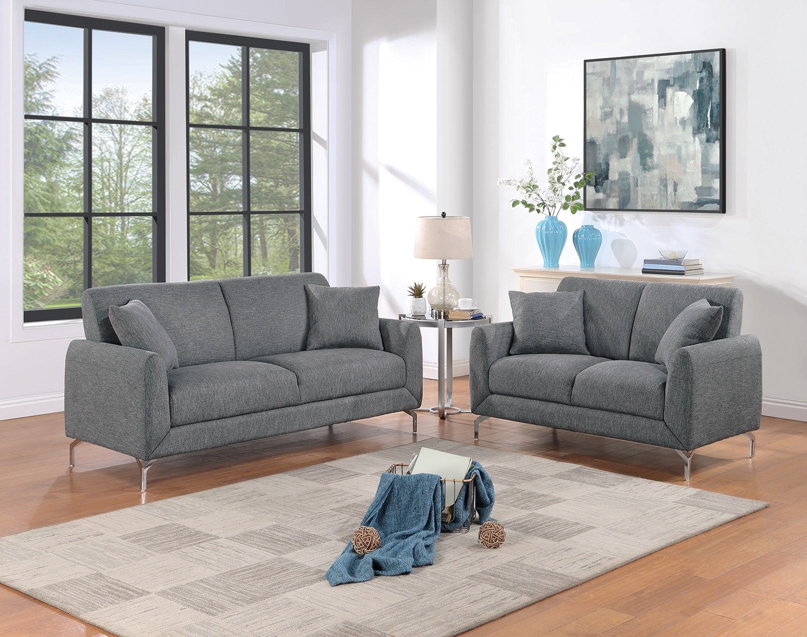 Modern grey fabric sofa with sleek metal legs in a stylish living room setting