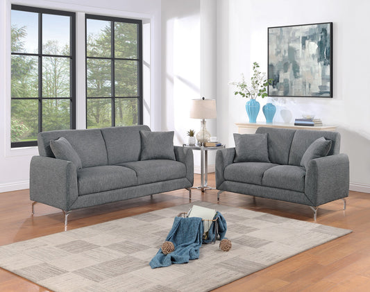 Modern grey fabric sofa with sleek metal legs in a stylish living room setting