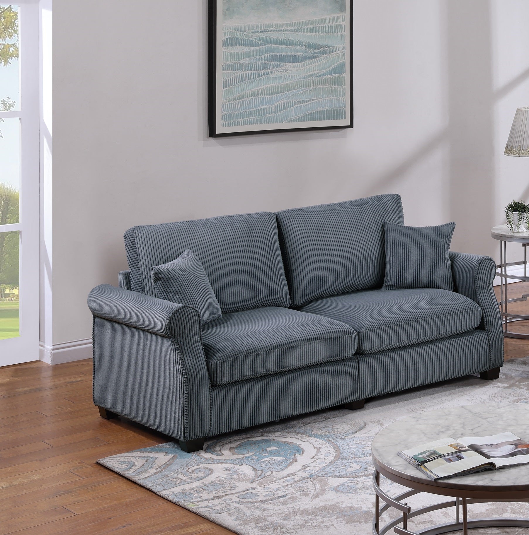 Textured gray corduroy sofa with rolled arms and accent pillows