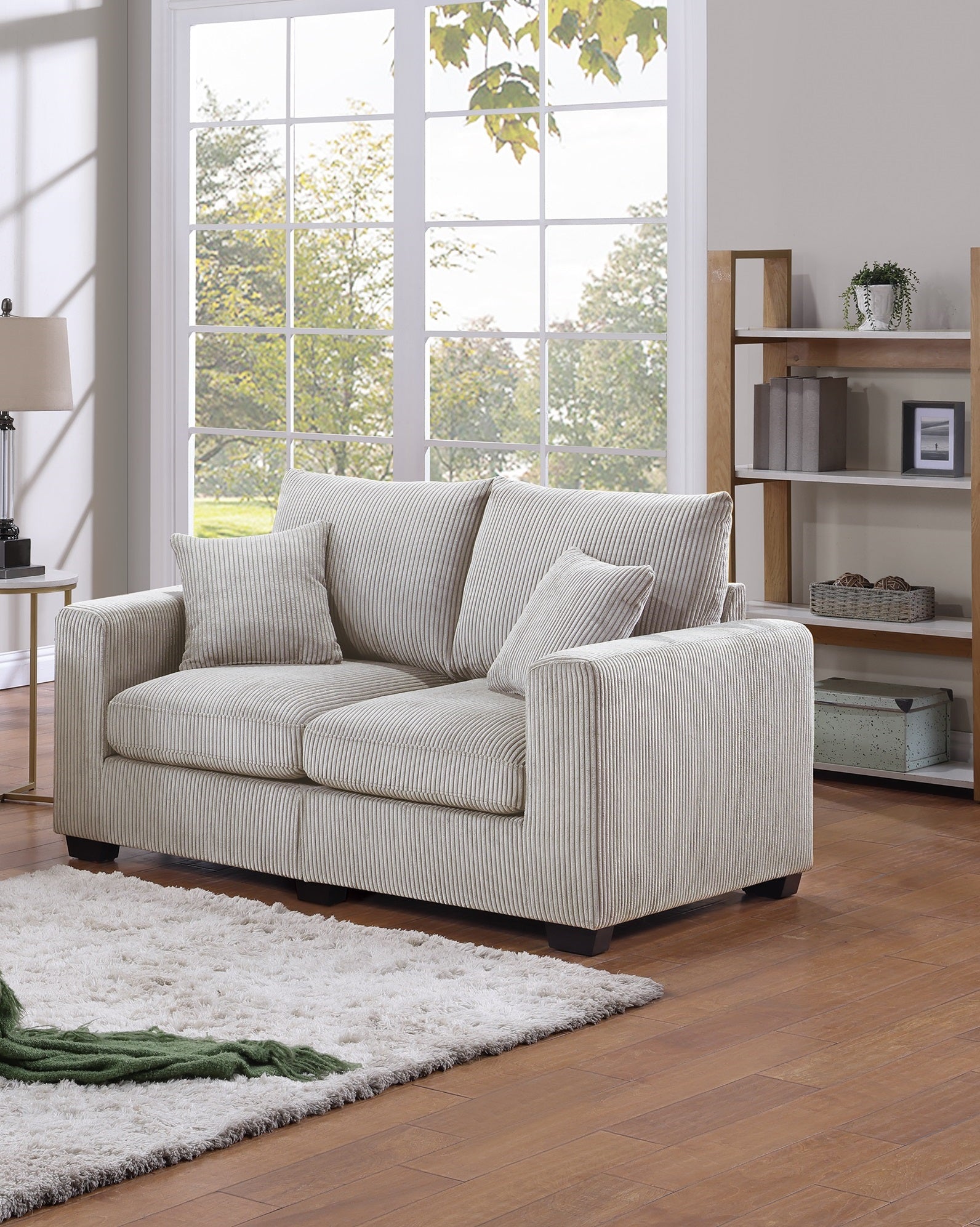 Cream corduroy loveseat with vertical ribbing and plush cushions