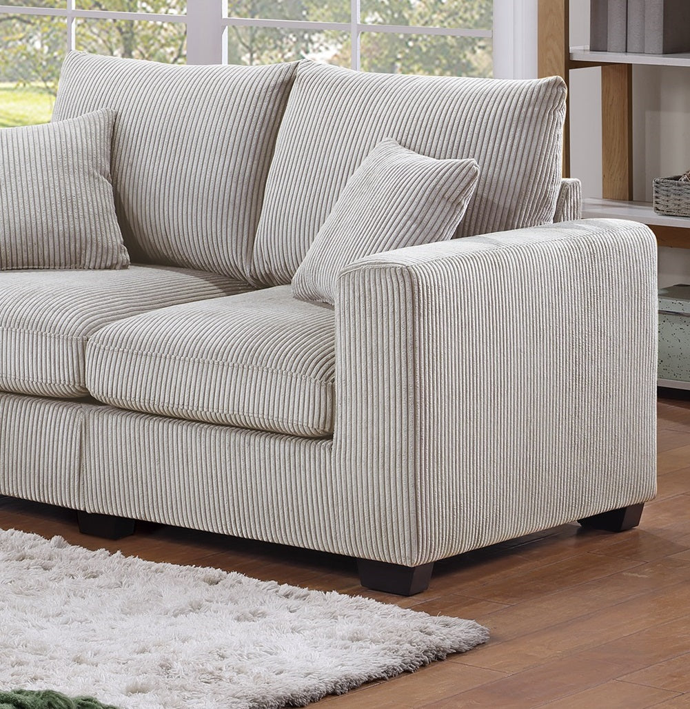 Plush corduroy sofa in light beige featuring deep seating and accent pillows