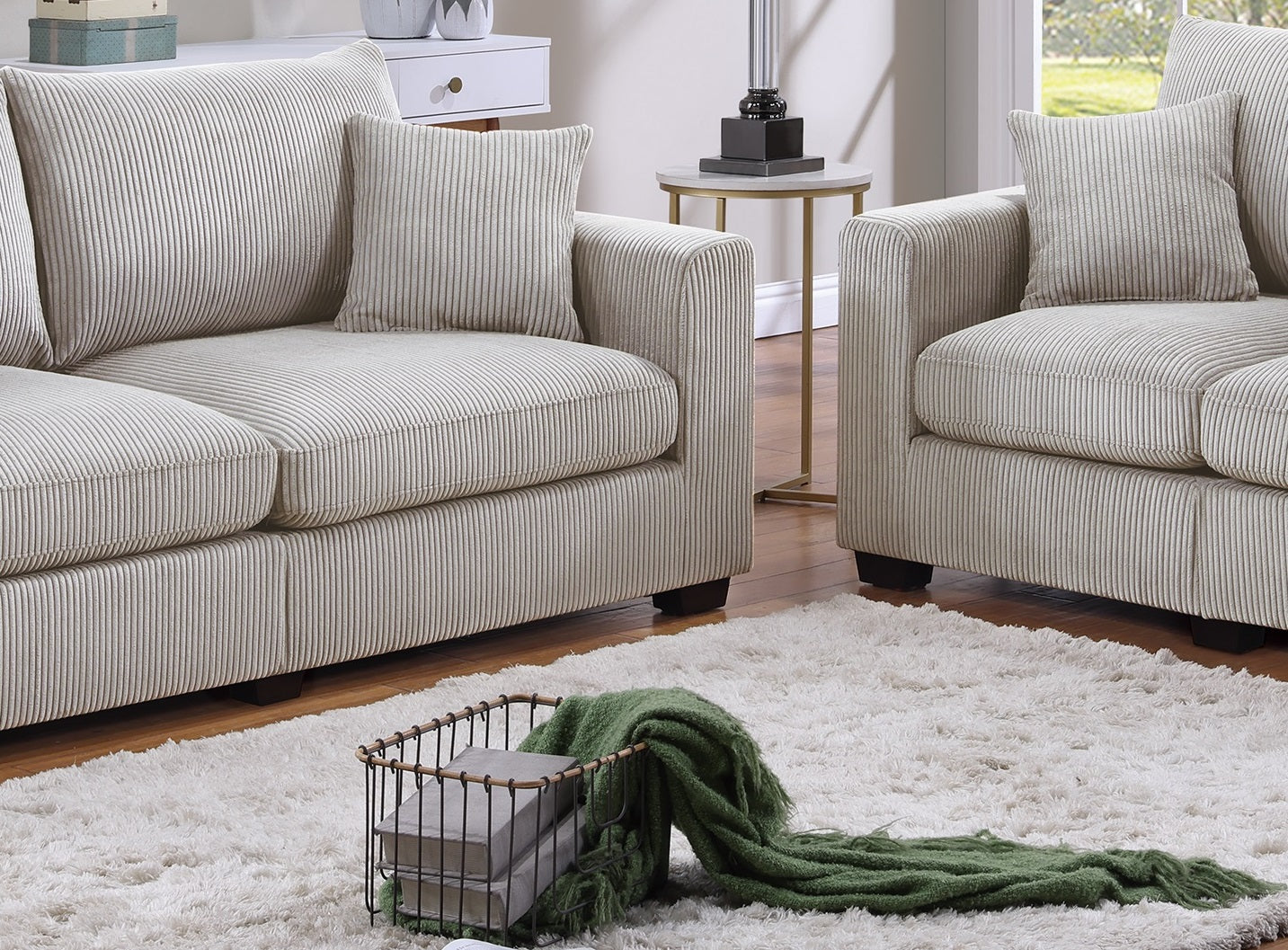 Cream corduroy sofa with plush cushions and matching throw pillows