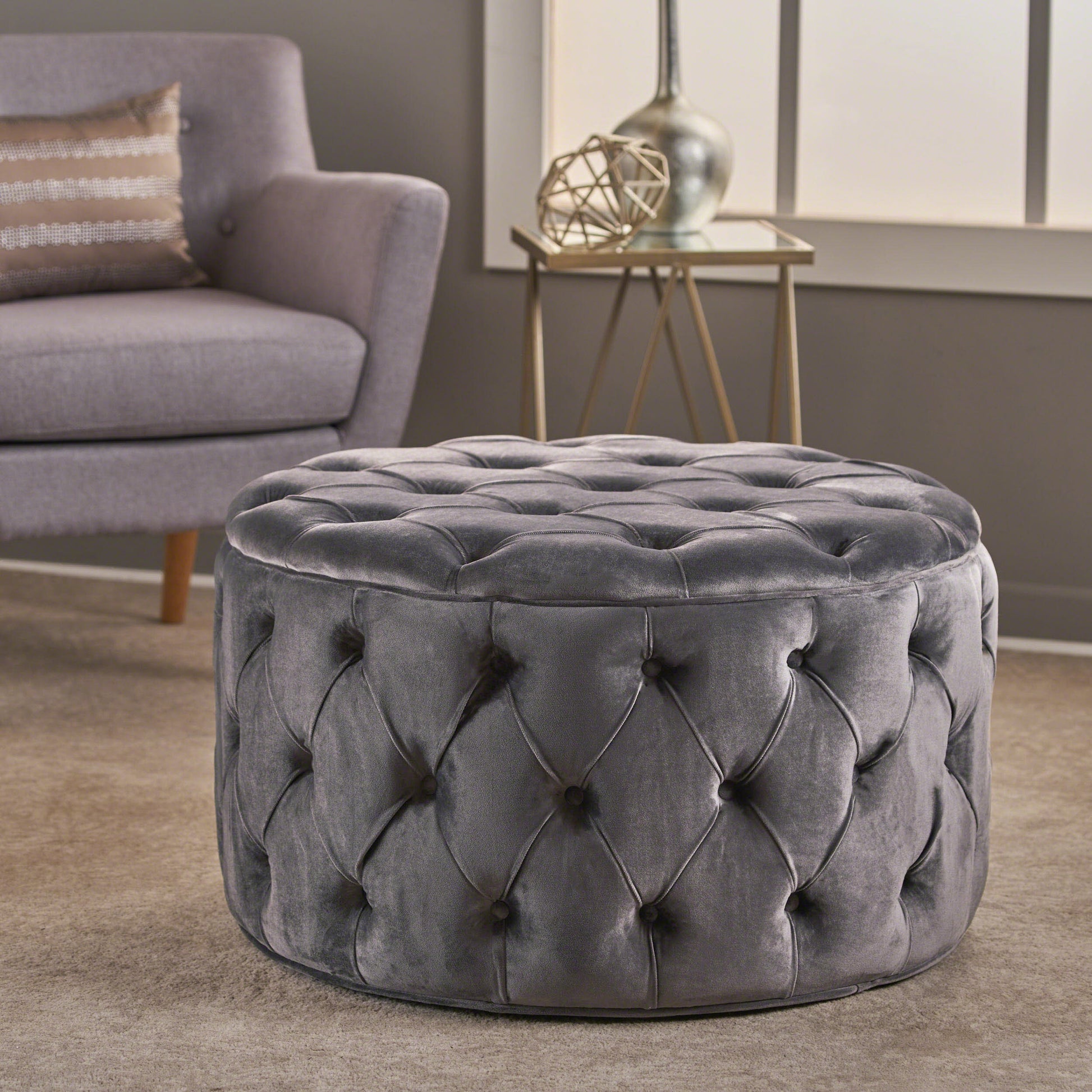 Gray velvet tufted round ottoman with button accents
