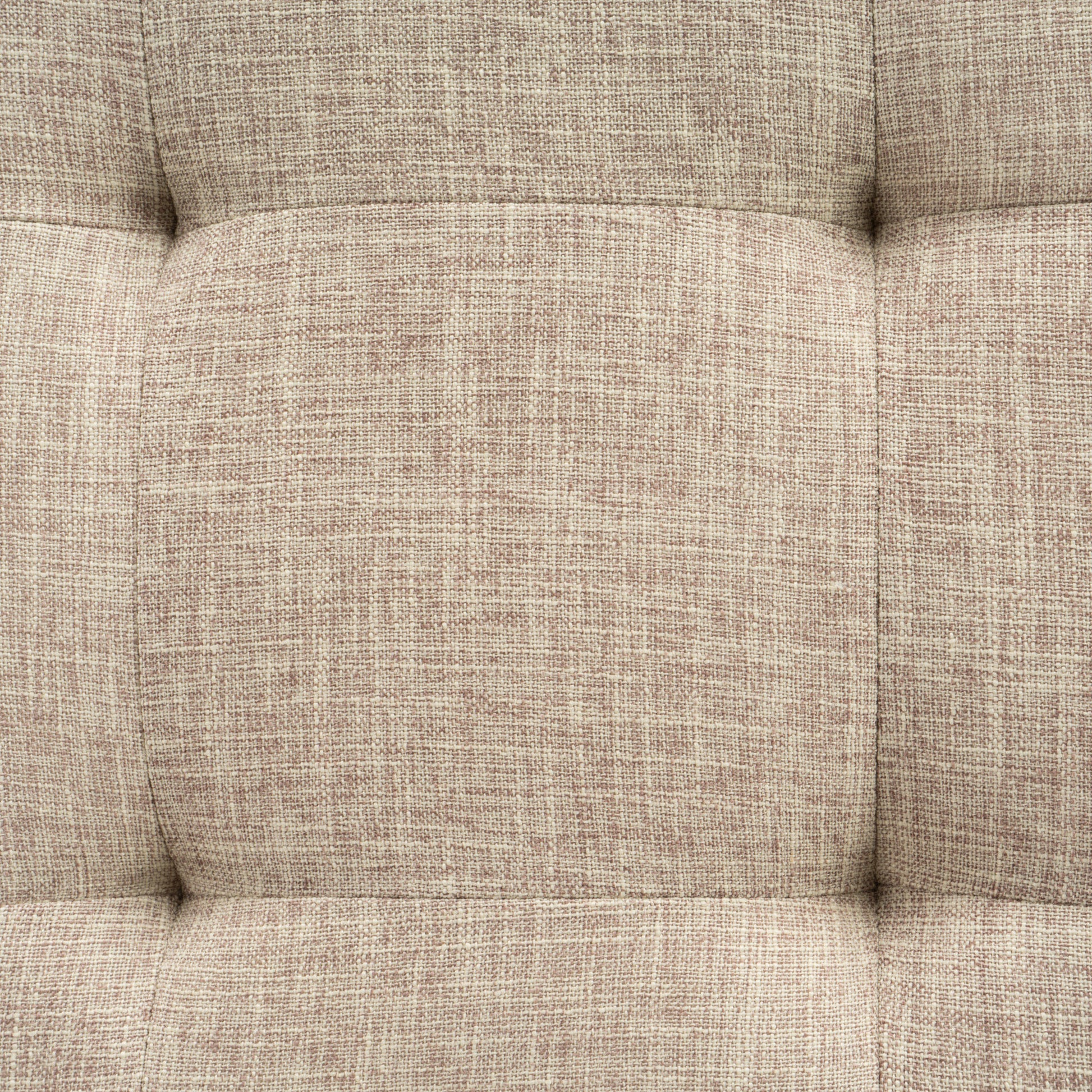 Closeup of textured neutral fabric upholstery with tufted detailing