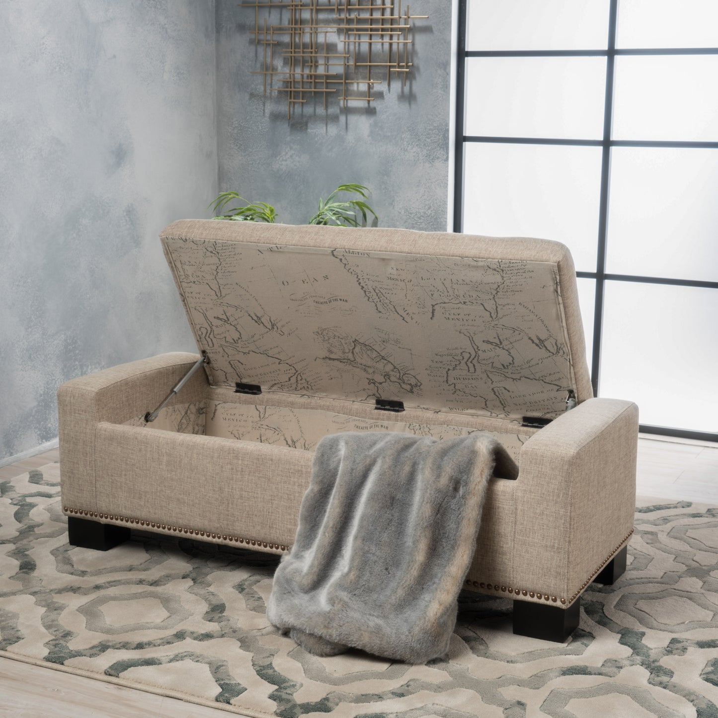 Beige linen storage ottoman with maplined interior and decorative nailhead trim