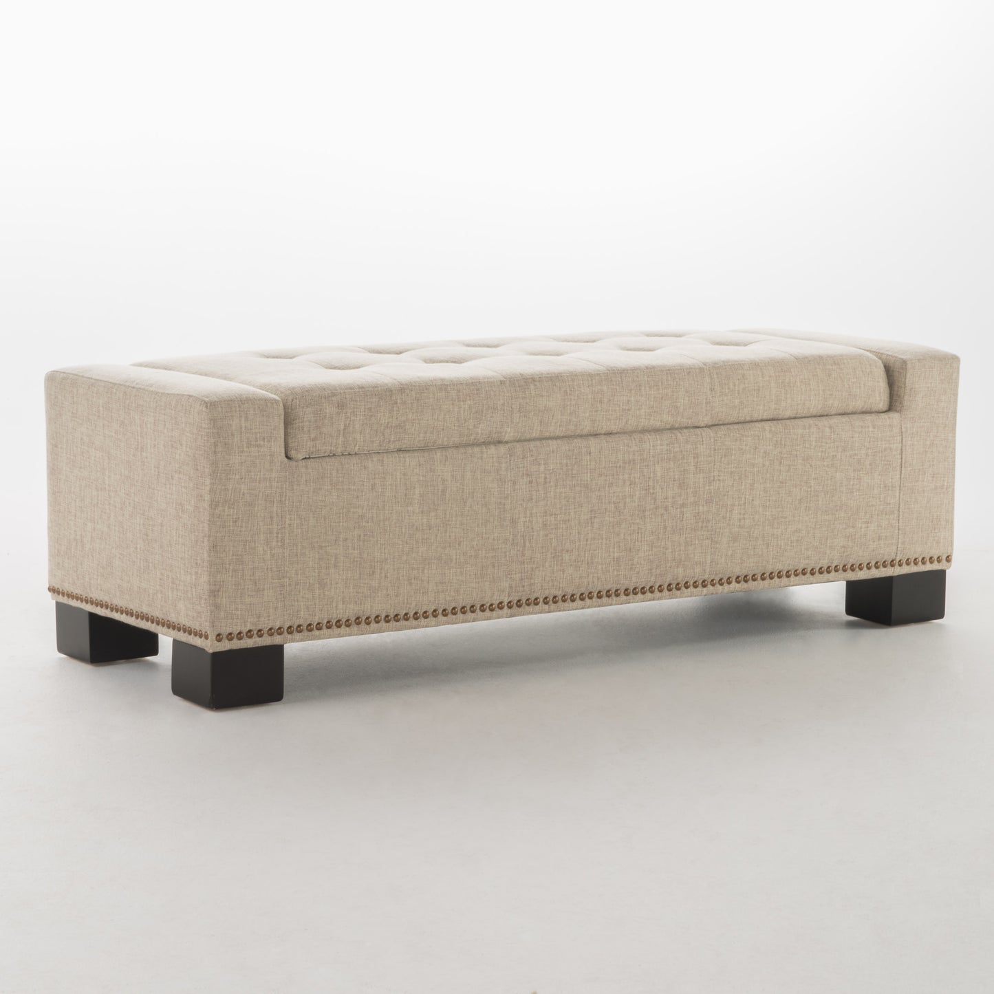 Beige linen storage bench with tufted top and nailhead trim