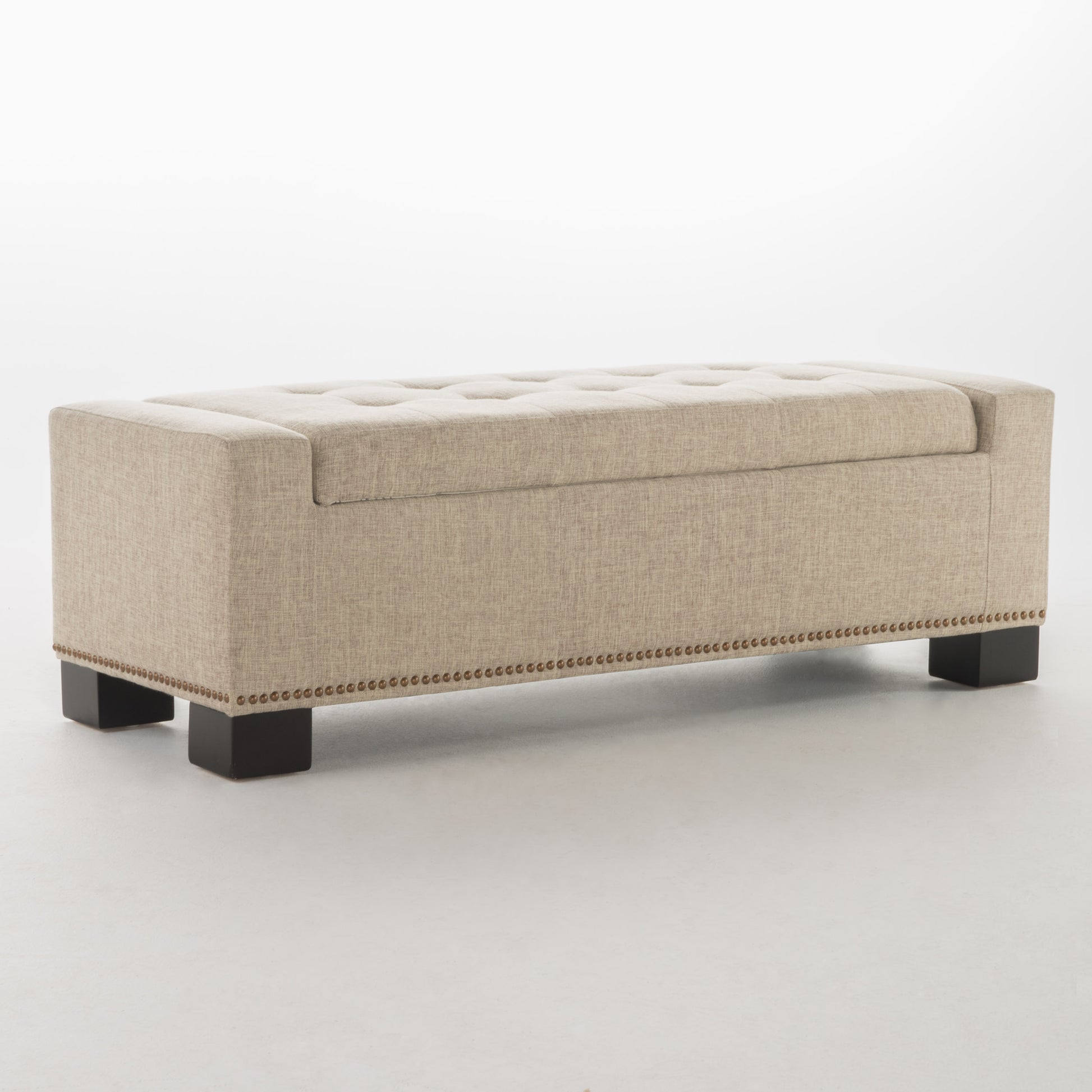 Beige linen storage bench with tufted top and nailhead trim